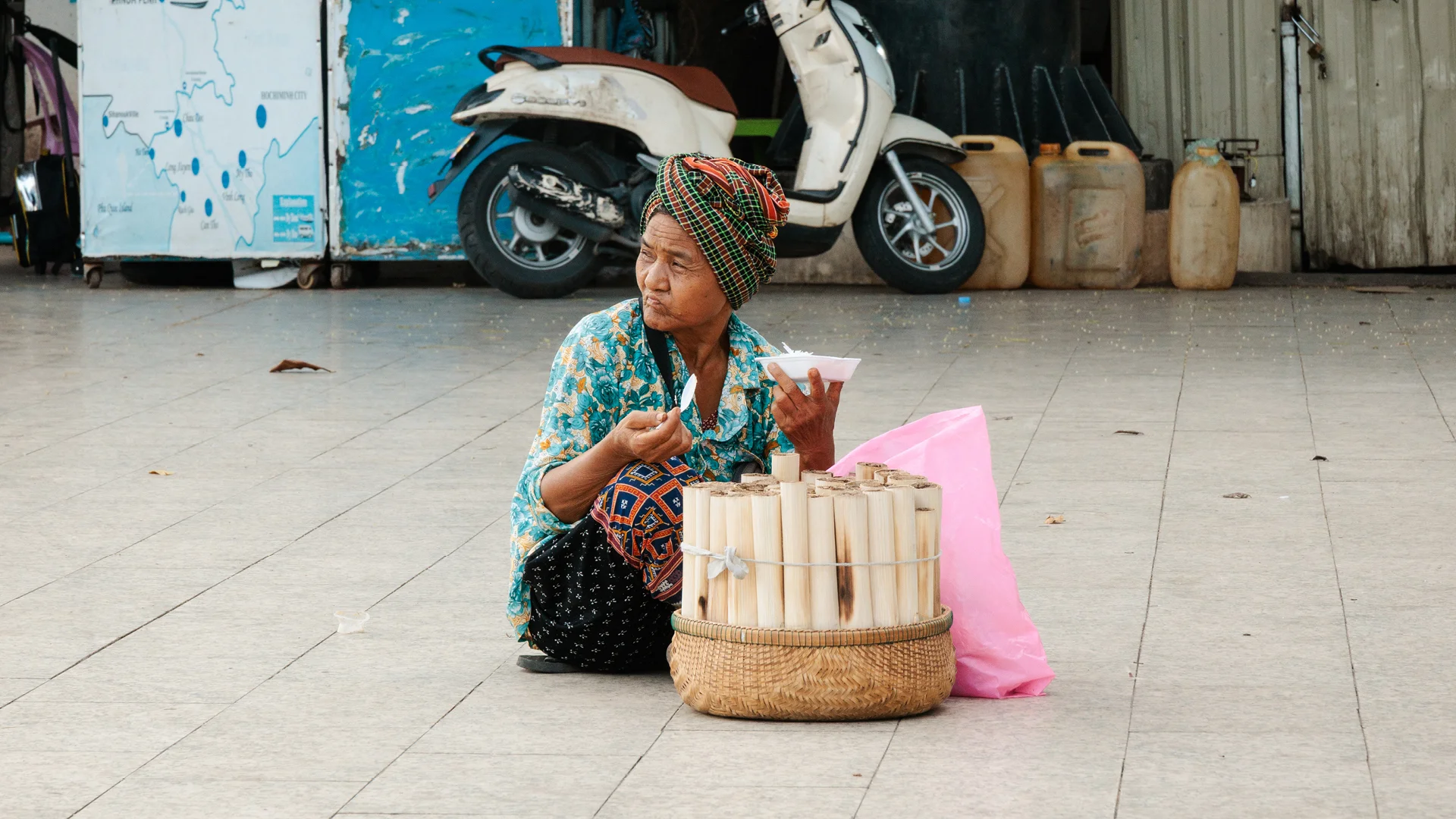 Food tour Phnom Penh - woman eating in the street