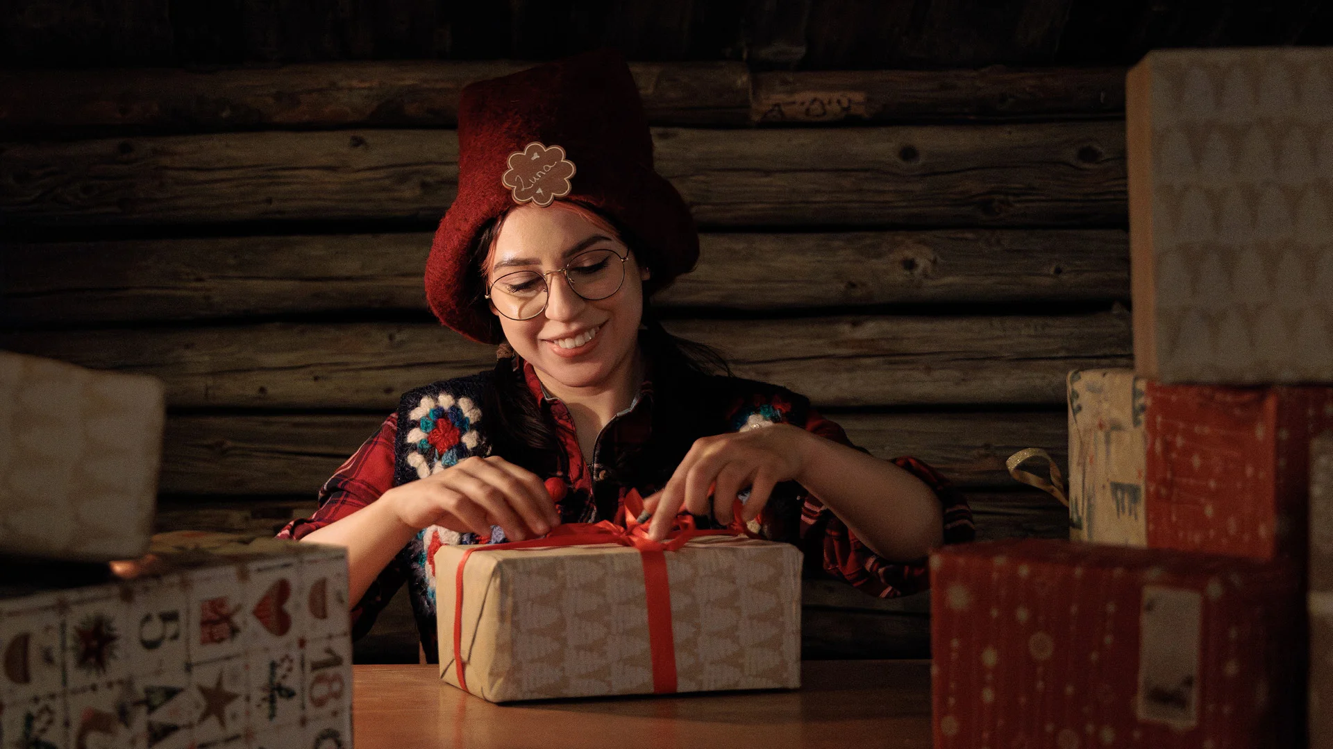 Elf wrapping a present in Santa Claus office Rovaniemi