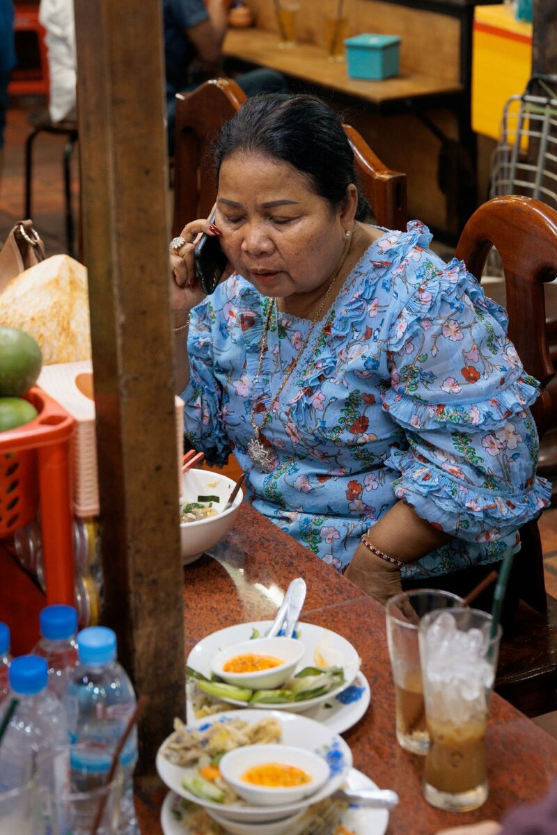 Woman on the phone in the food court of the Russian Market