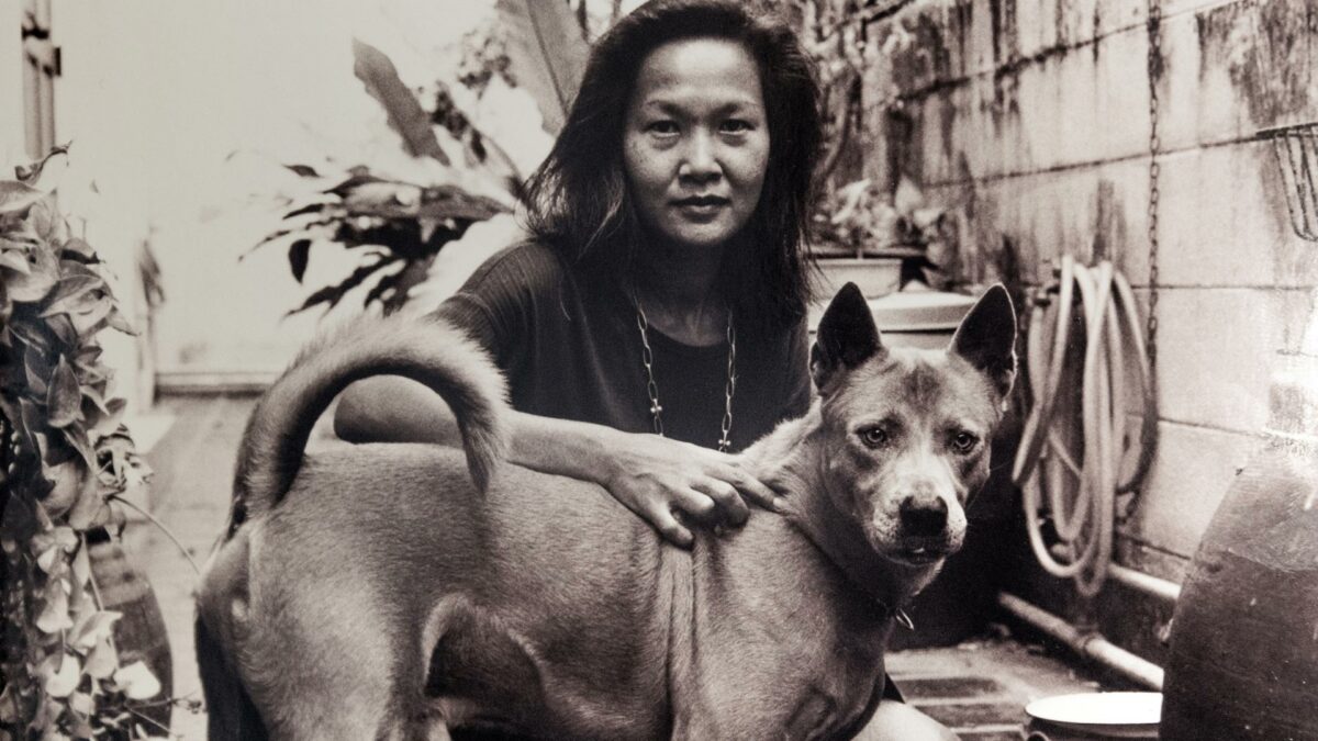 Archive photo, black and white Jine's wife with a dog.  