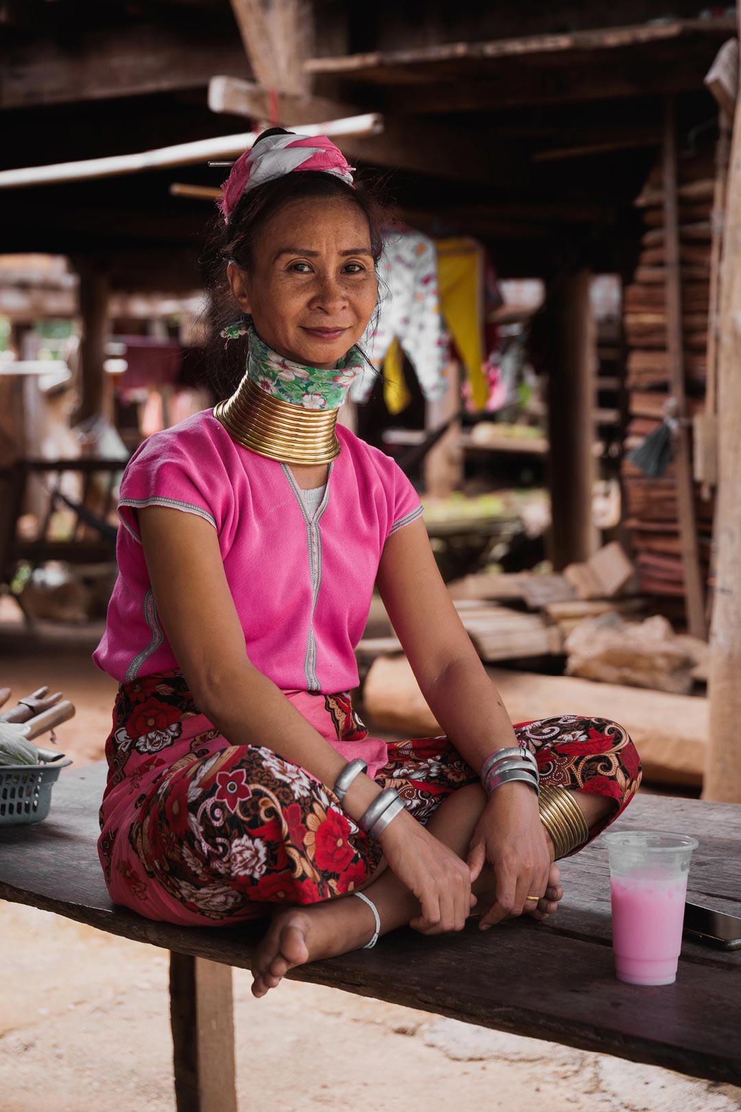 Ma Pang (kayan woman) - sitting in front of her house