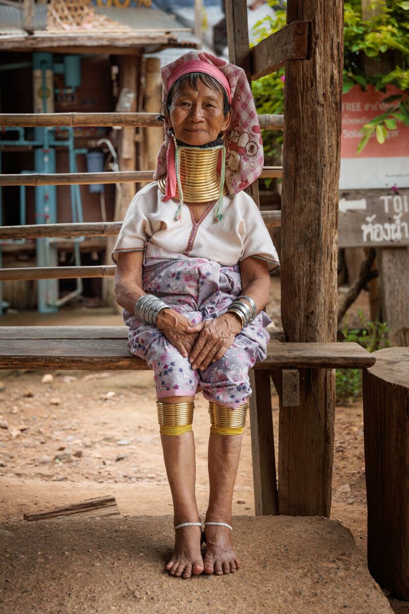 Mu Kler elder of the Kayan tribes sitting  in the village of Huay Pu Keng