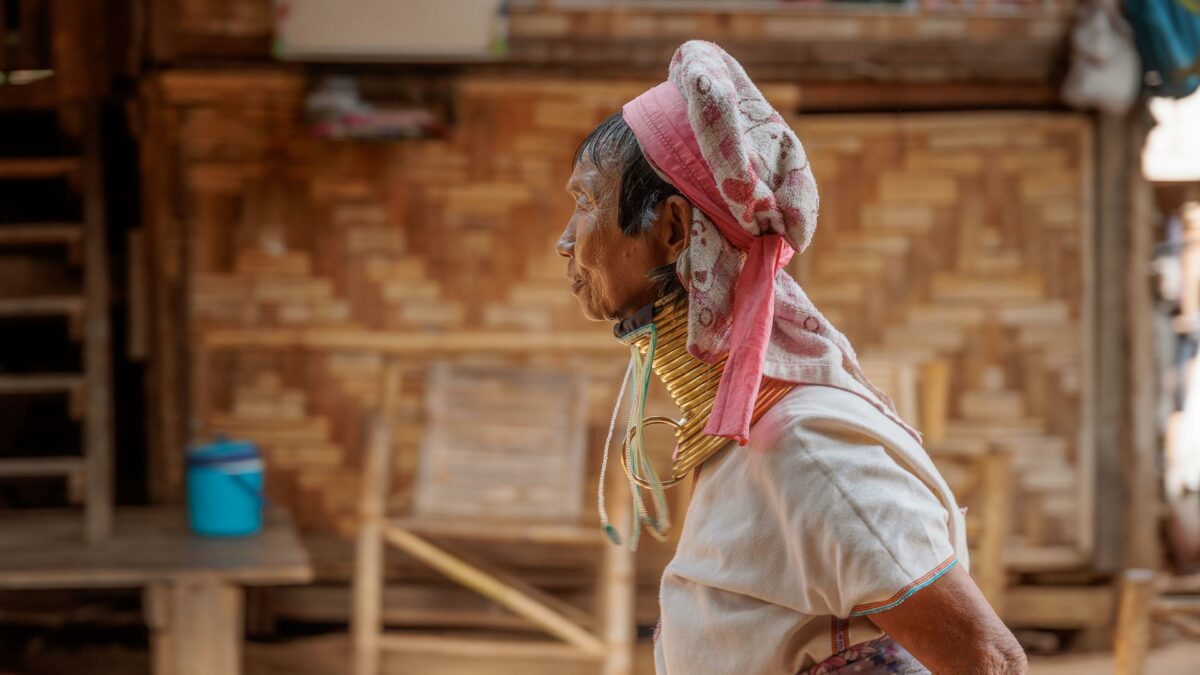 Mu Kler, walking with he stick in the village of Huay Pu Keng