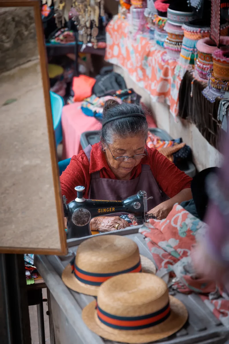 Portrait of an old women sewing in the Hmong village close to Chiang Mai