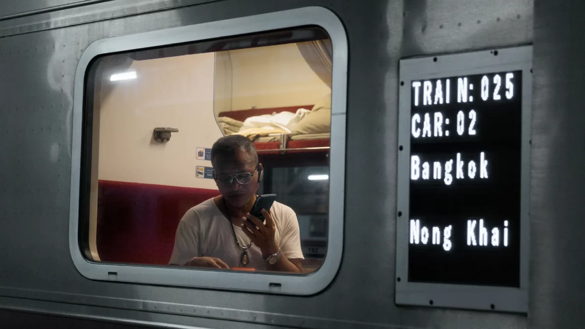 Men in the Bangkok, Nong Khai train. Bangkok, Thailand