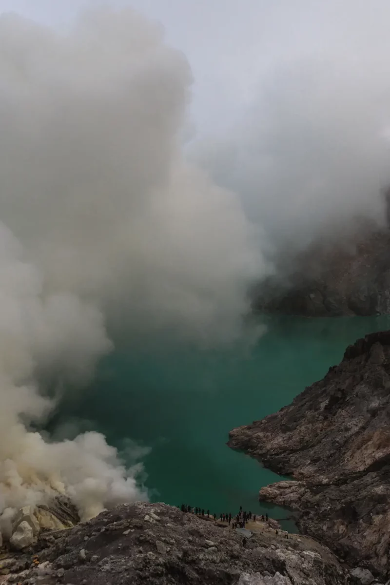 view on Ijen volcano and lake, with sulfuric smoke