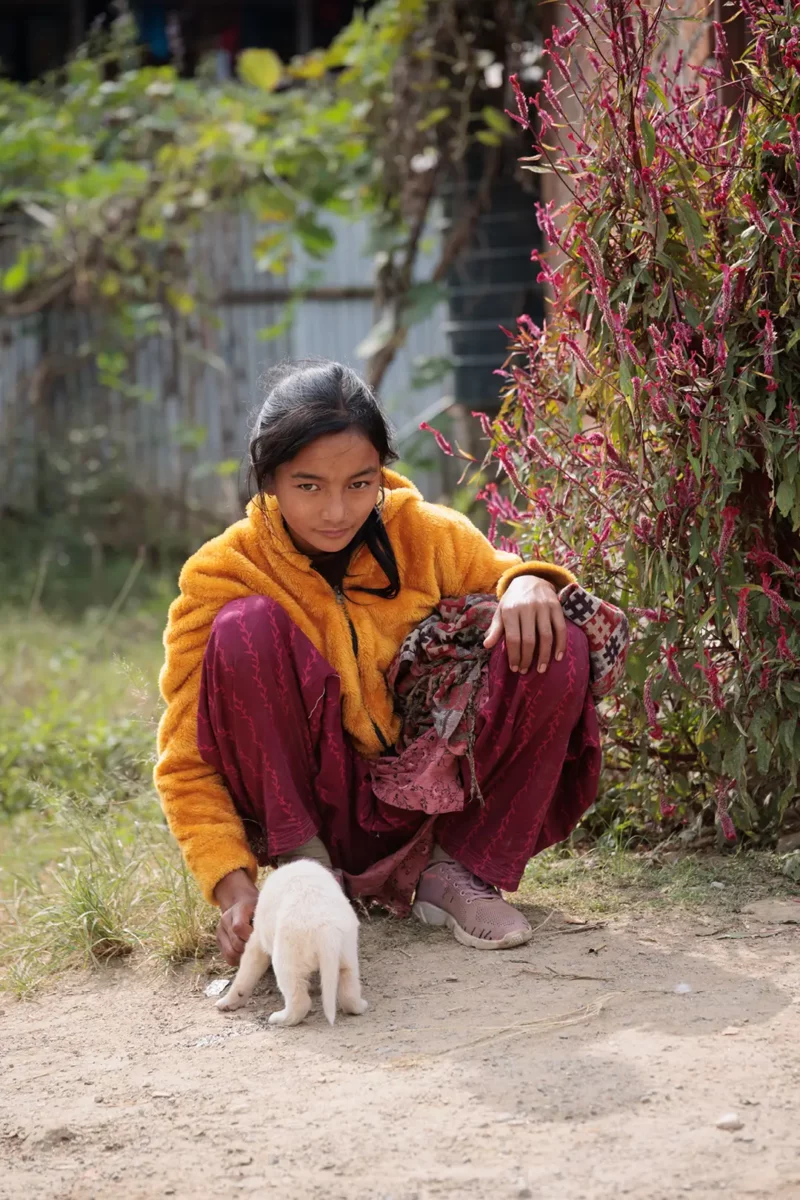 young girls playing with a puppy, on the way to the mountain with my Yoga retreat Nepal