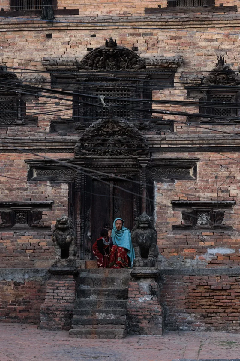 Woman and daughter in sitting front of a house Bhaktapur Nepal