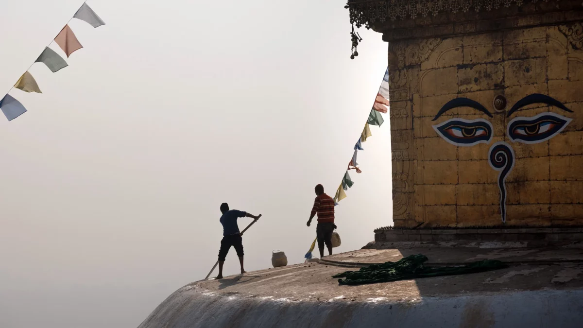 Monk Repainting the Stupa on top of the Swoyambhu Mahachaitya the Monkey temple Kathmandu Nepal