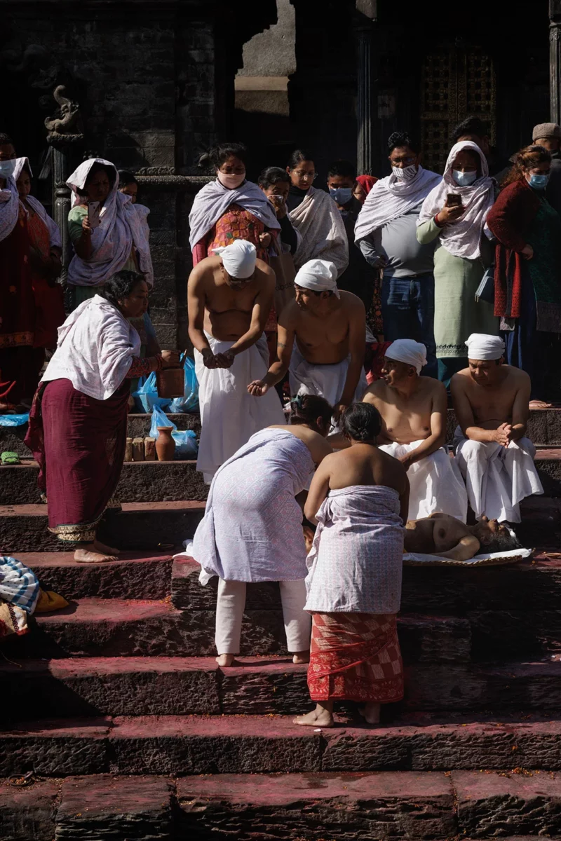 Family cleaning a body in the temple of Pashupatinath in Kathmandu Nepal
