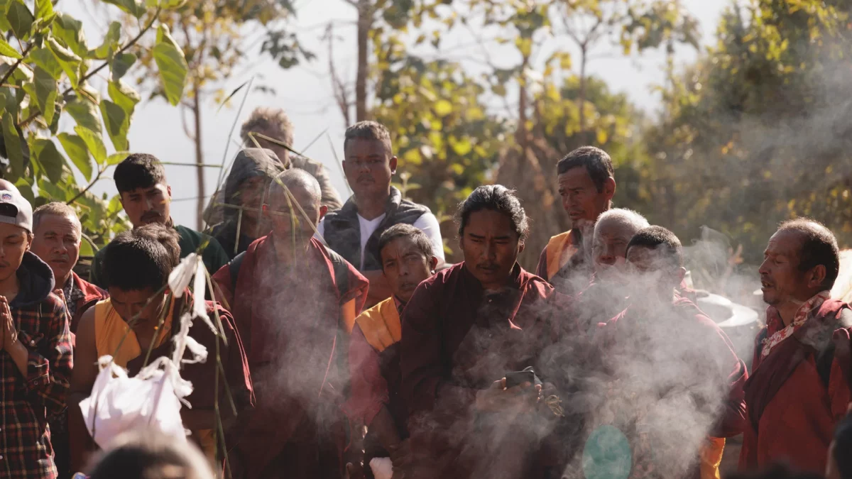 Monks and Lama praying during a cremation ceremony in Nepal