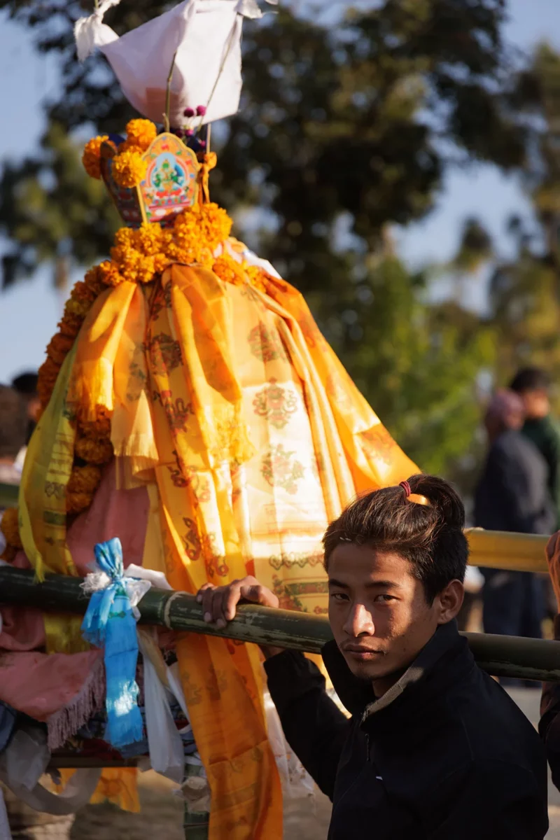 Young boy carring a body during a death ceremony in Nepal
