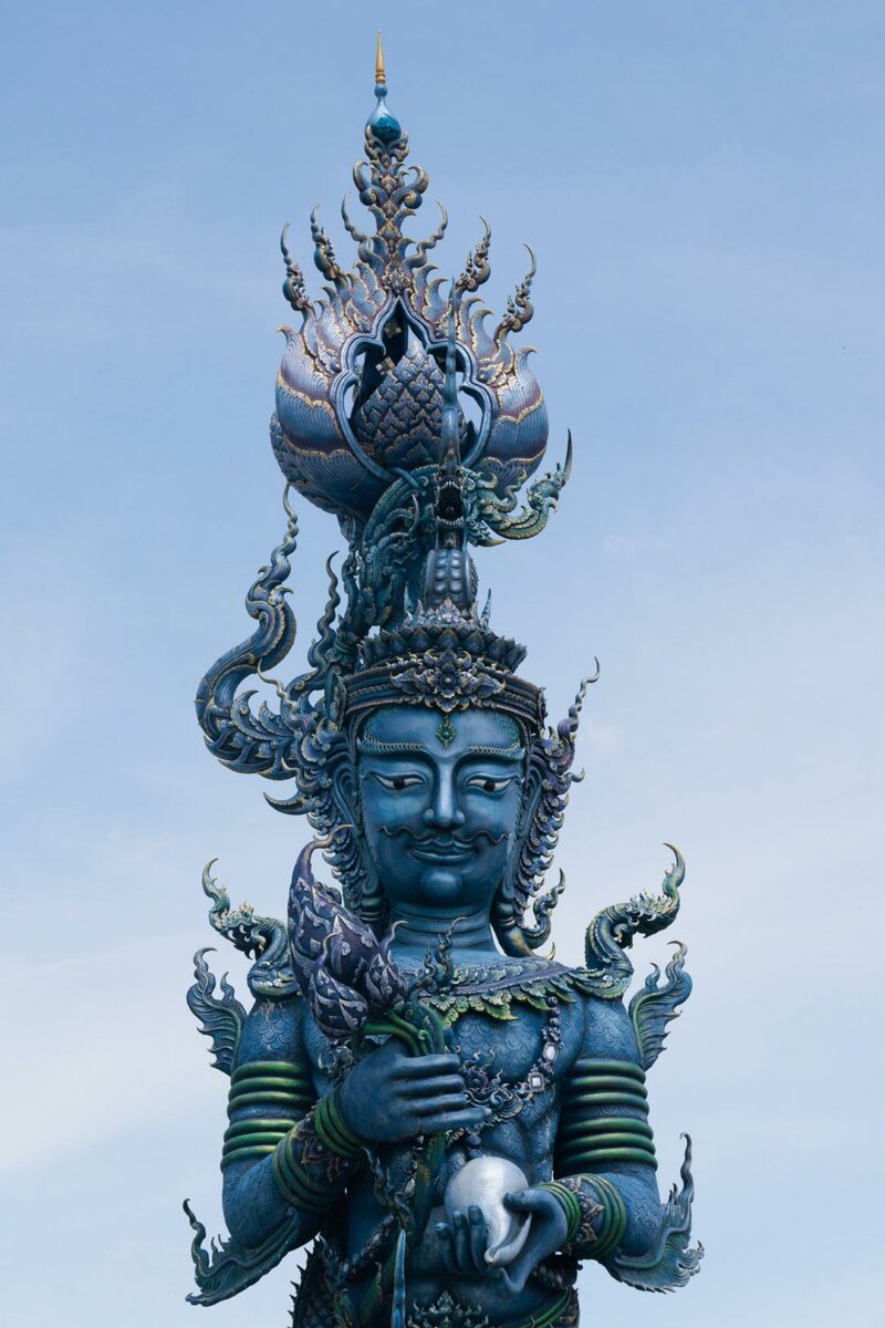 Blue statue in the entrance of Wat Rong Suea Ten aka blue temple, Chiang Rai, Thailand