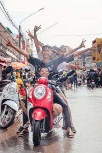 new year in cambodia. bunch of teenager in a motorbike in the street of Kampot