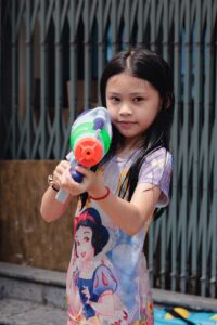 Kid with water gun in the street of Kampot during Choul Chnam Thmey, the Cambodian New Year