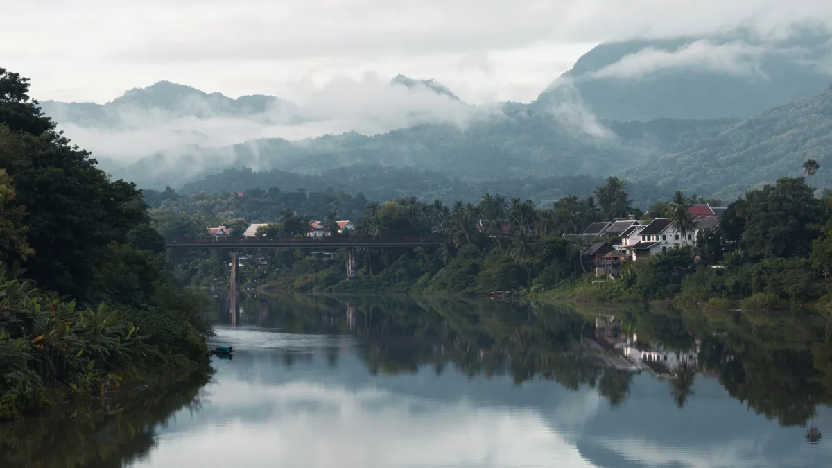 View of the Nham Kang river and old French bridge in the old town of Luang Prabang in Laos