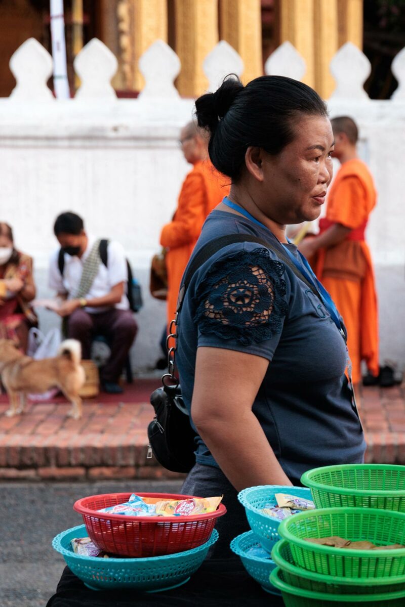 Ethical tourism in Southeast Asia, vendor selling candy to give to the monks in Luang Prabang Laos