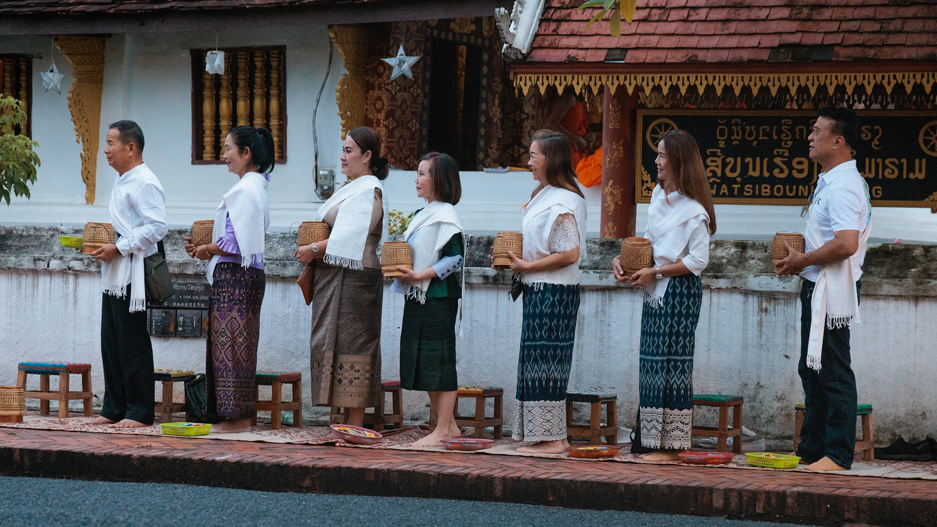 Ethical tourism in Southeast Asia? Asia, group getting it's picture taken during the alms ceremony Luang Prabang