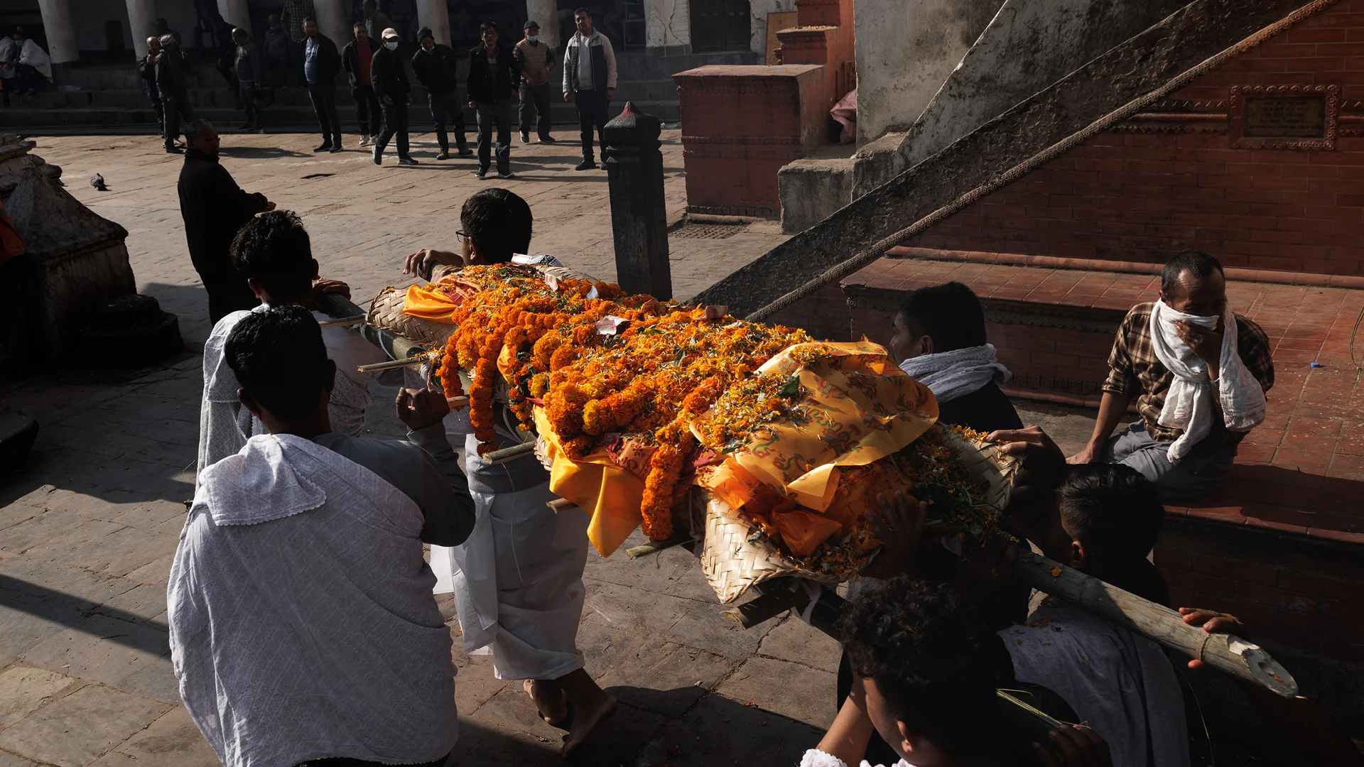 family carrying a body to the Shmashana for the cremation ceremony, Pashupatinath temple Nepal