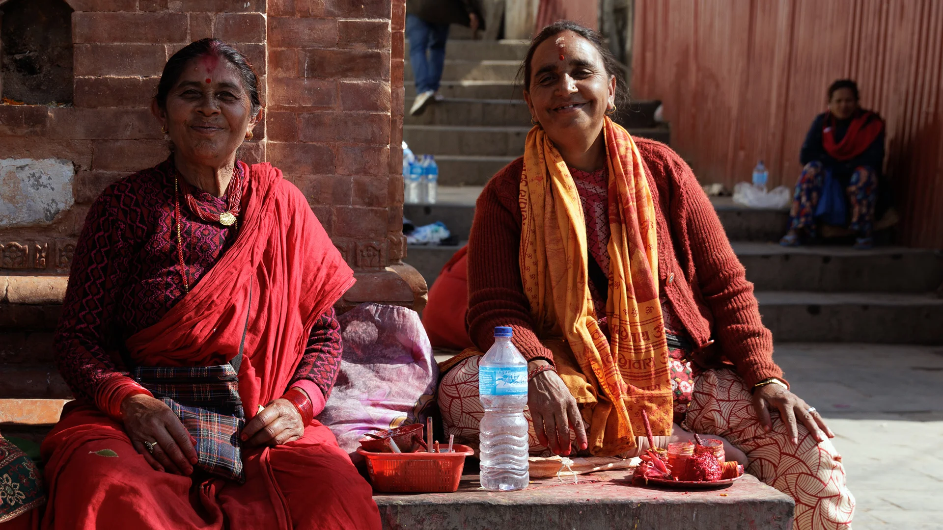 Women selling bracelet and offering tika Pashupatinath temple Nepal