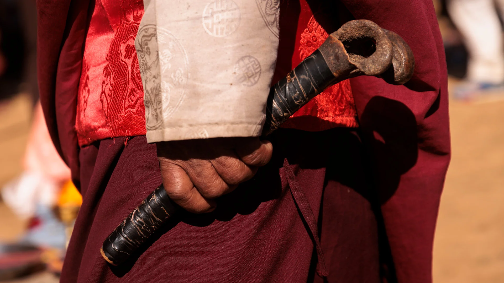 Lama holding a flude made of human bone in nepal