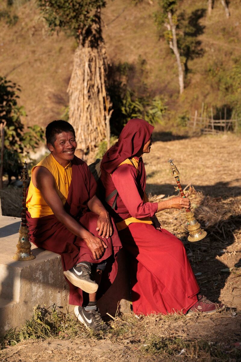 Two monks taking a rest during a sacred ritual in Nepal