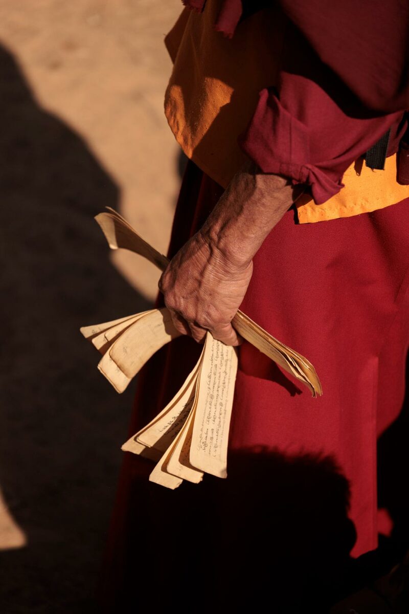 Great lama holding prayer scroll during a sacred ritual in a small village of nepal