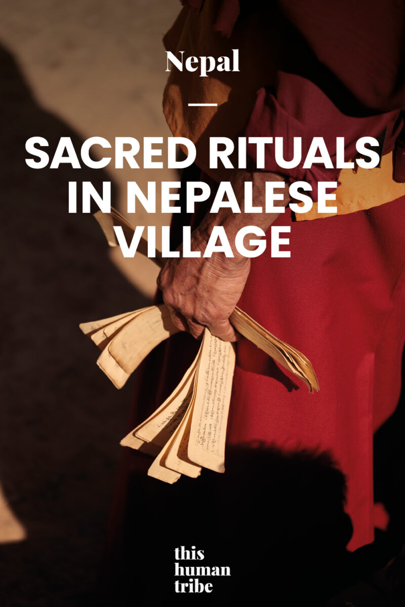 Monk holding prayer scroll during a ritual in rural Nepal