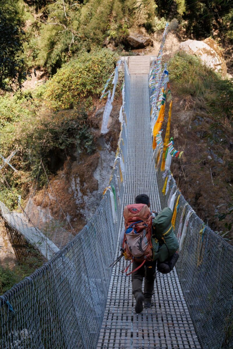 Sherpa crossing a nepali bridge in Langtang Valley