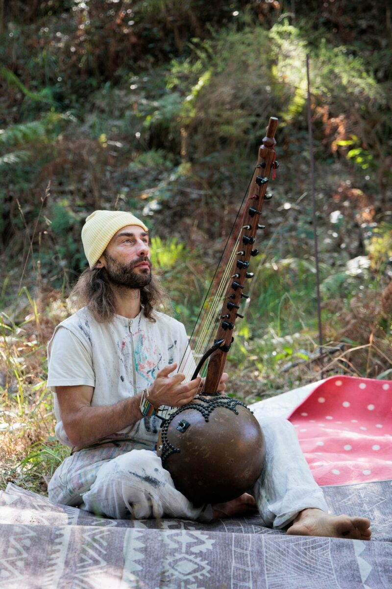 Man playing music at the gathering of tribe