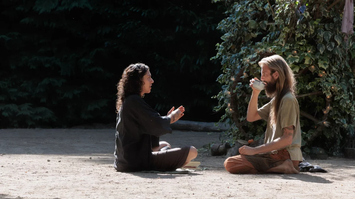 Woman and man sitting face to face during a regenerative festival in Ponte di Lima