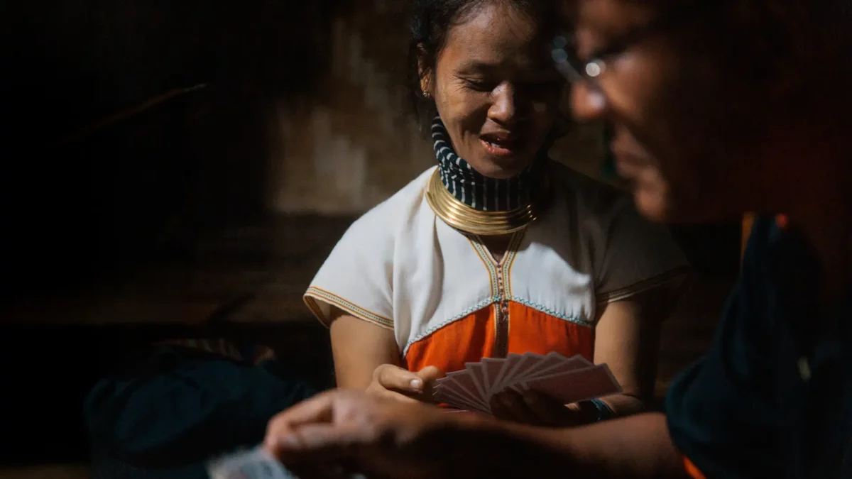 Kayan family playing cards, in Huay Pu Keng, the long neck village in Thailand