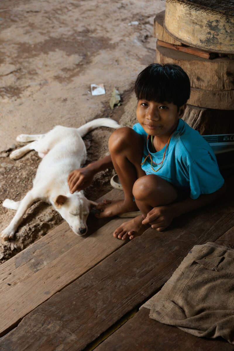 Young Kayan girl with her dog in the longneck village of Huay Pu Keng - Thailand