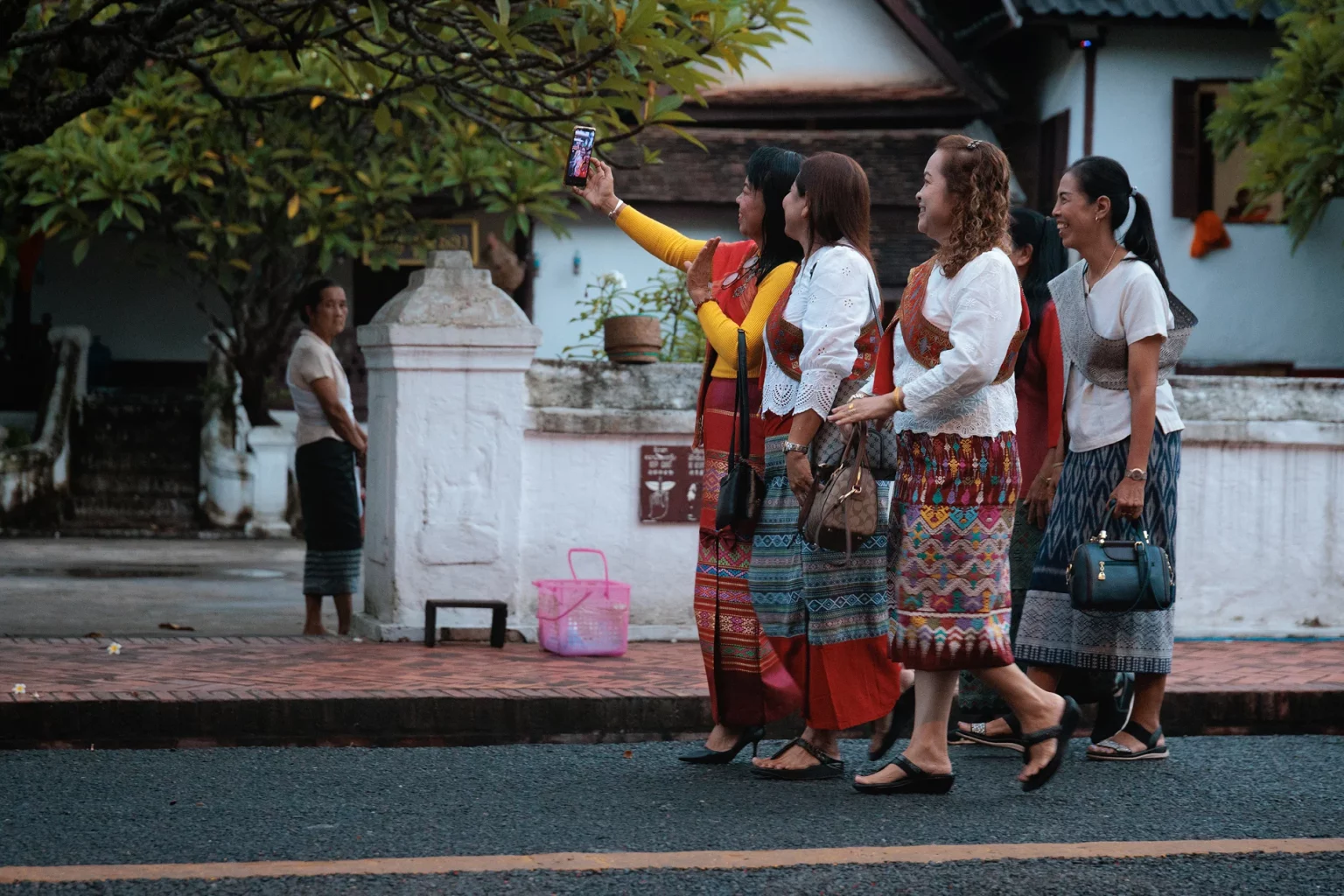 Asian tourist during alms ceremony in Luang Prabang Ethical tourism in Southeast Asia