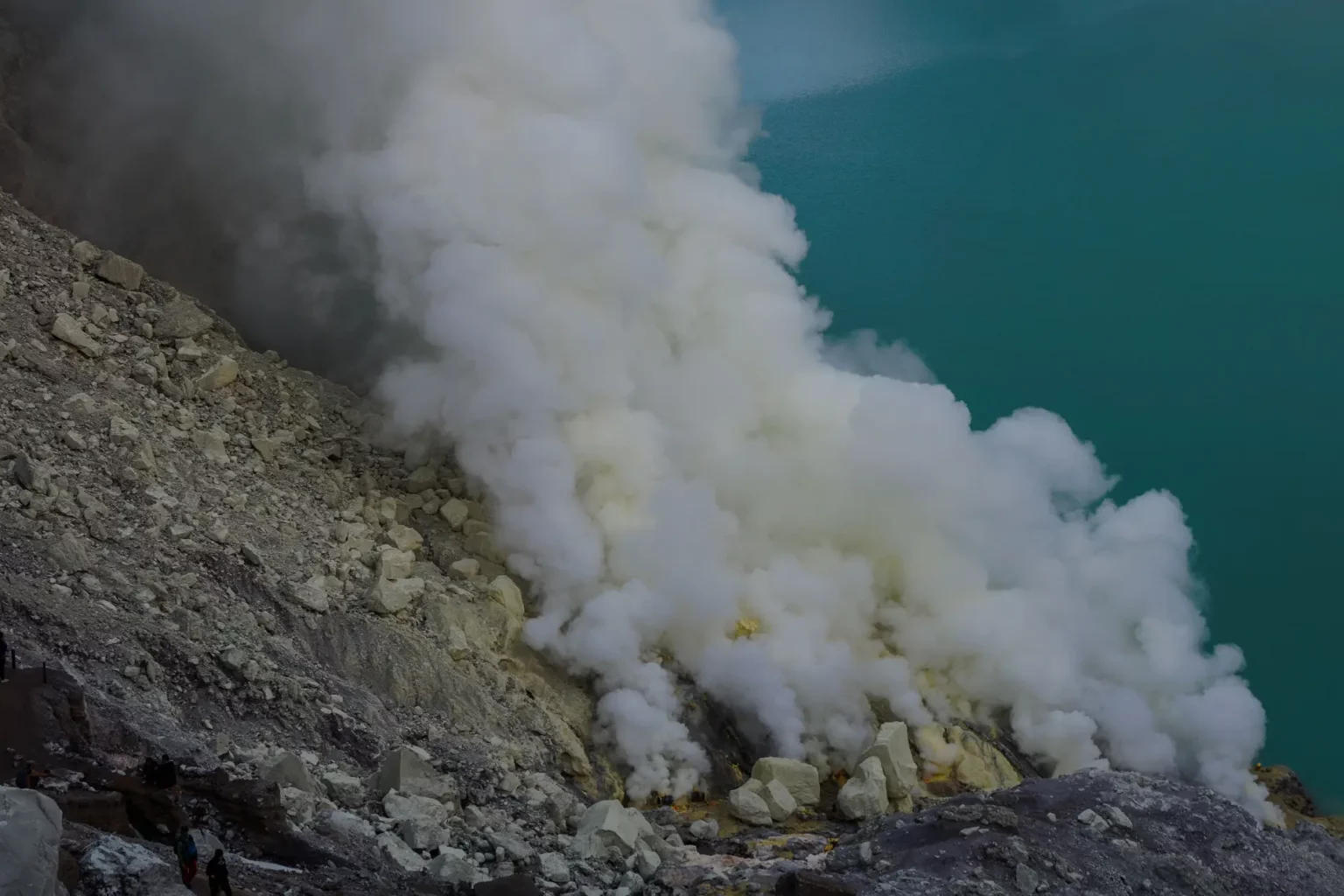 view on Ijen volcano and lake, with sulfuric smoke